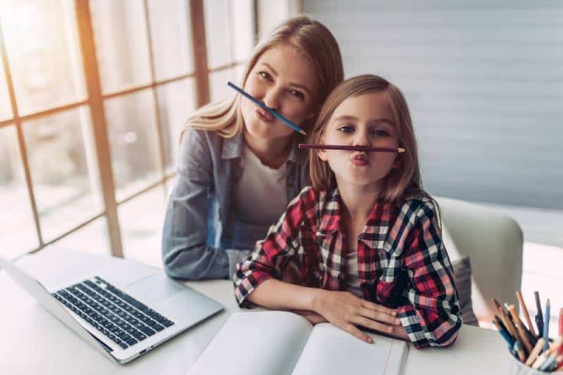 mother and daughter having fun while studying