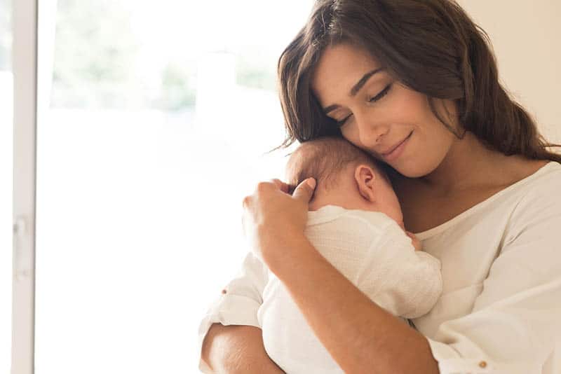 woman holding baby mother motherhood