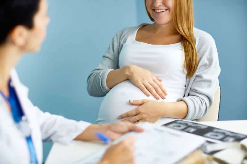 pregnant woman consulting with doctor