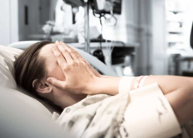 woman crying in hospital bed