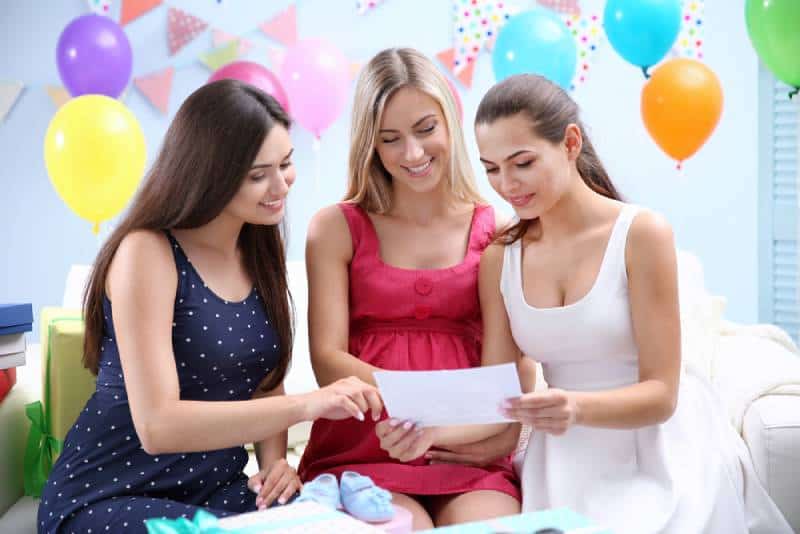 Pregnant woman and friends at baby shower party