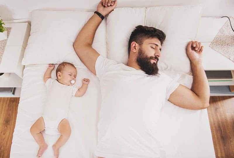 dad and baby sleeping funny