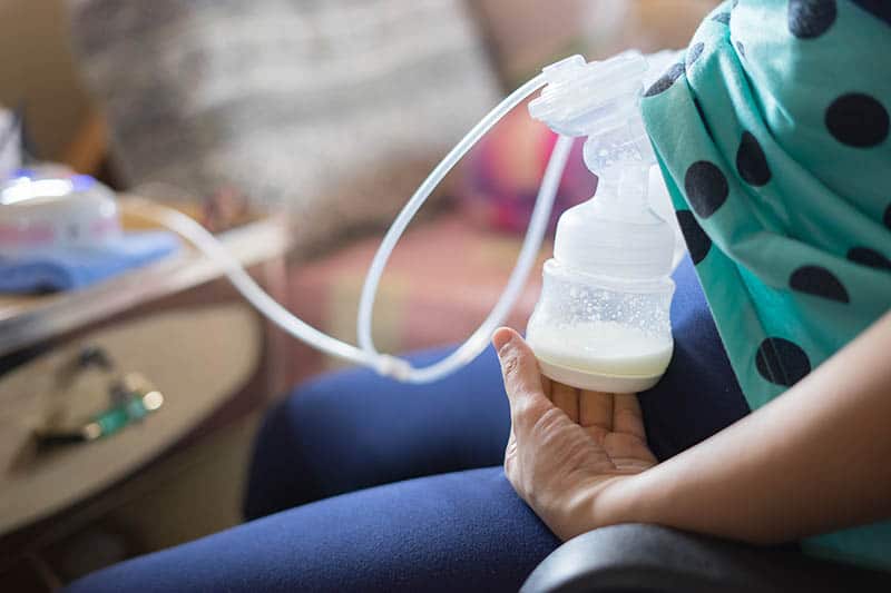 woman breast pumping milk