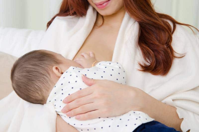Mom breastfeeding her baby in a room