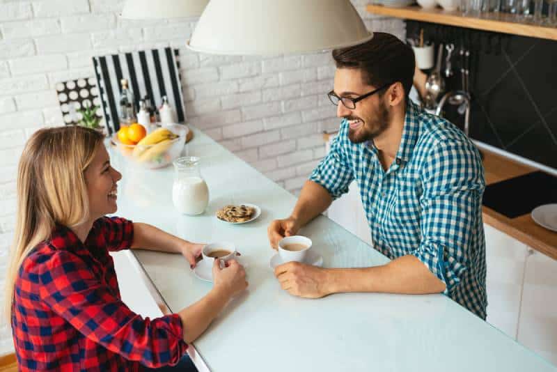 Jong stel dat samen lacht en koffie drinkt