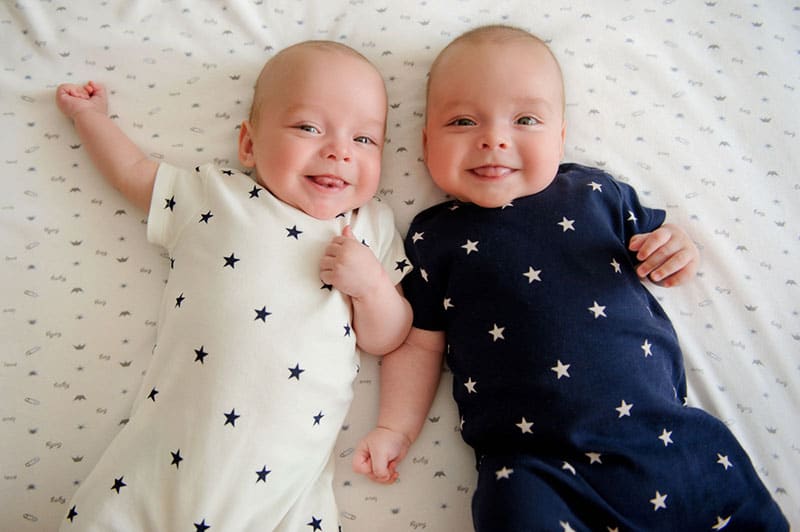 little baby twins lying on the bed