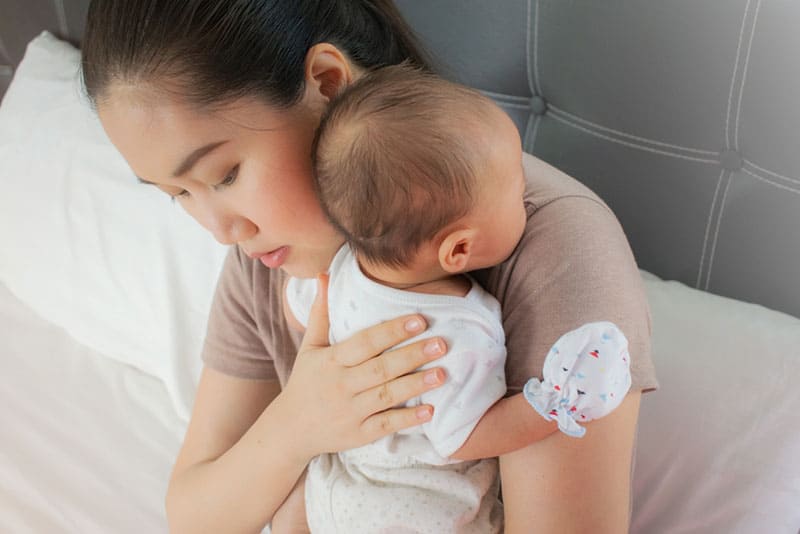 young mother burping the baby