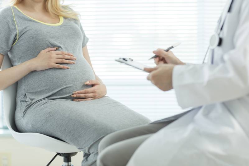 pregnant woman sitting at doctor's office