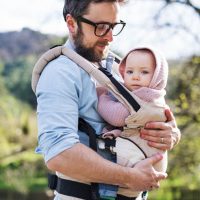 father carrying baby in the carrier