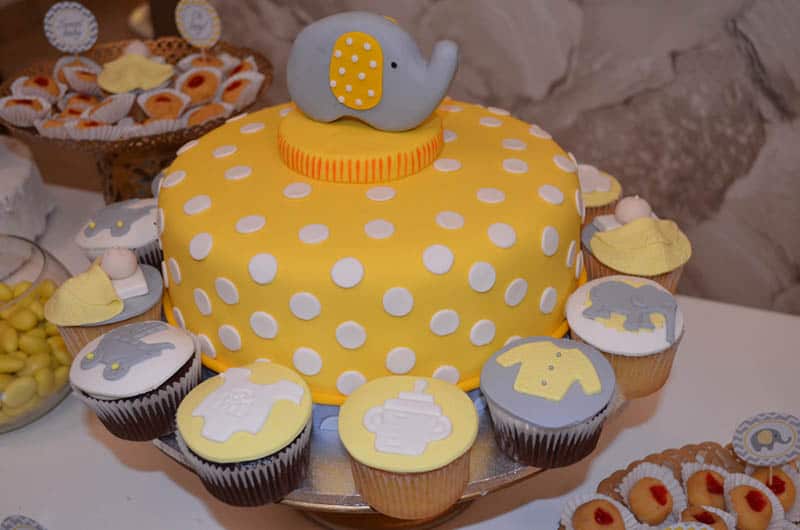 Yellow baby shower cake with elephant decoration