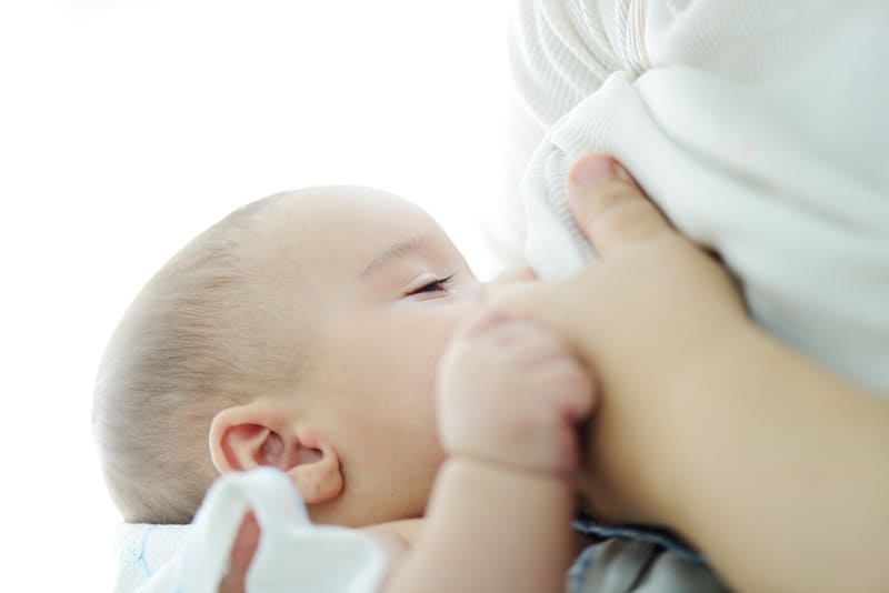 mother breastfeeding her newborn baby