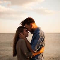 romantic couple cuddling during the sunset