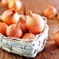 raw onion in basket placed on the table
