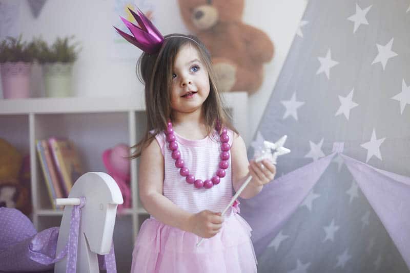 cute little girl dressed up as a princess with crown on head