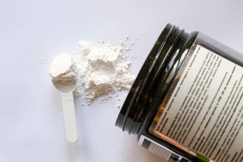 sport supplement creatine powder spilled on the table