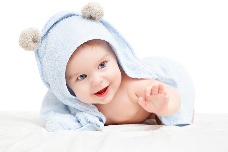 sweet baby boy wearing a towel after bathing