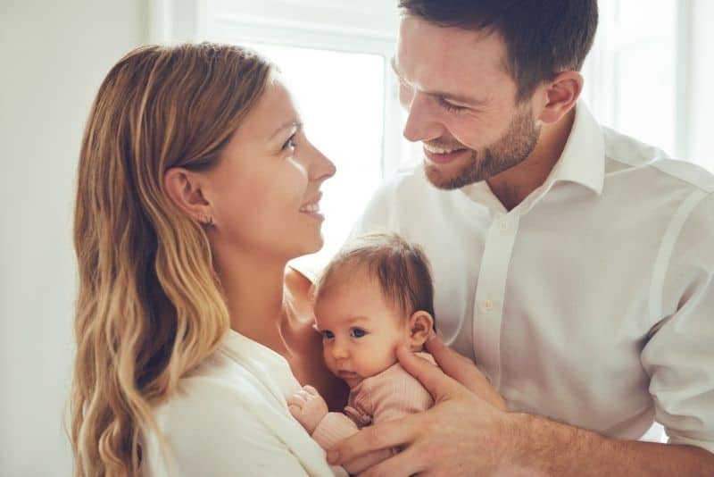 happy parents holding a newborn baby girl