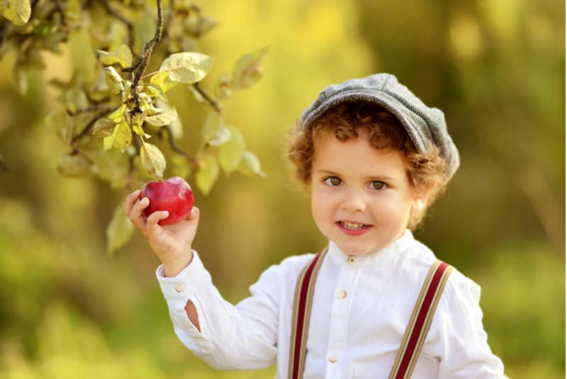 little boy with curly hair outdoors