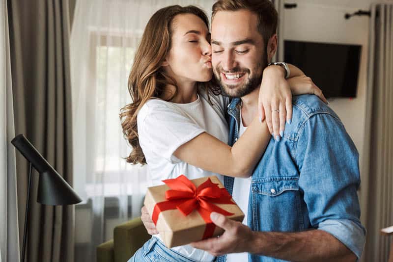 beautiful woman kissing husband for birthday