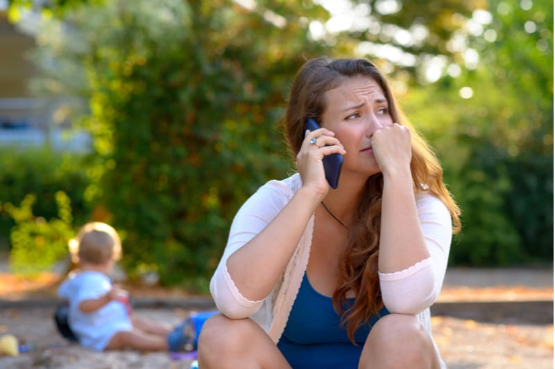 worried mother talks on the phone