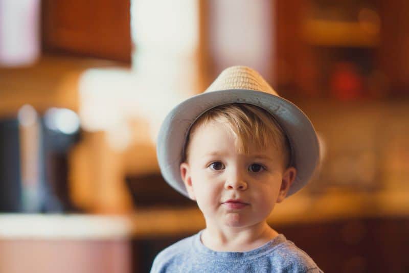 little boy wearing a fedora