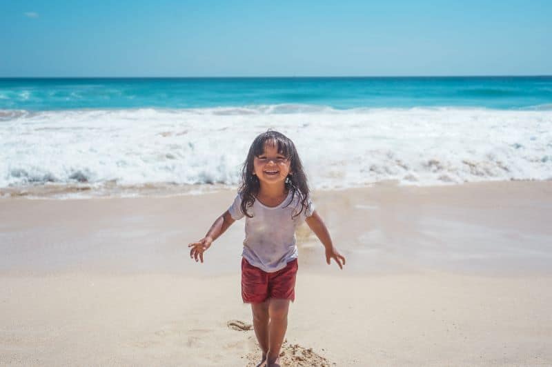 little girl having fun at the beach